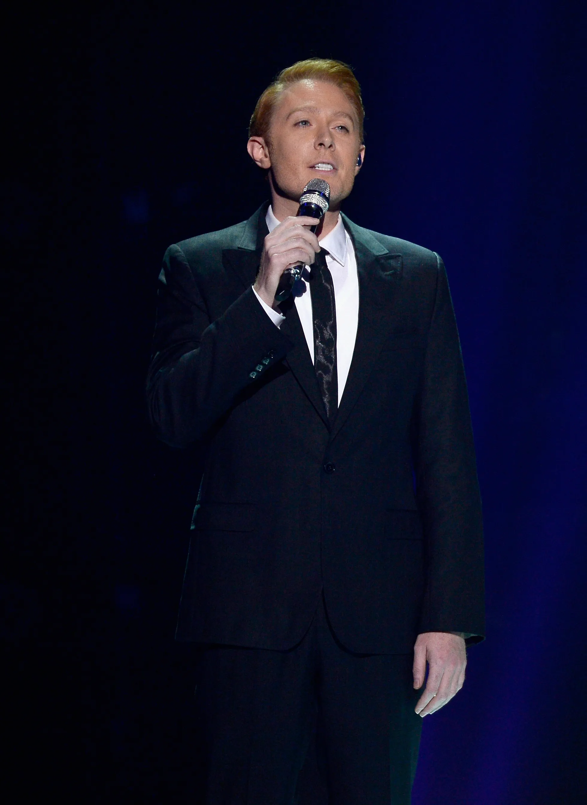 Singer Clay Aiken performing on stage.
