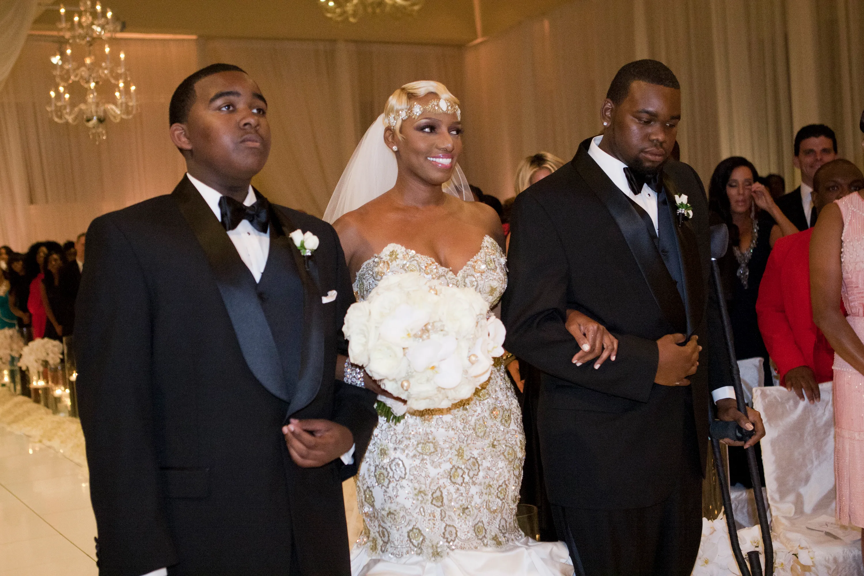 Nene Leakes walks down the aisle at her wedding reception with her two sons.