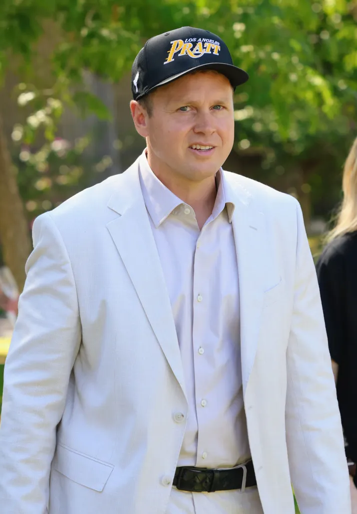 Spencer Pratt in a cream suit and a black 
