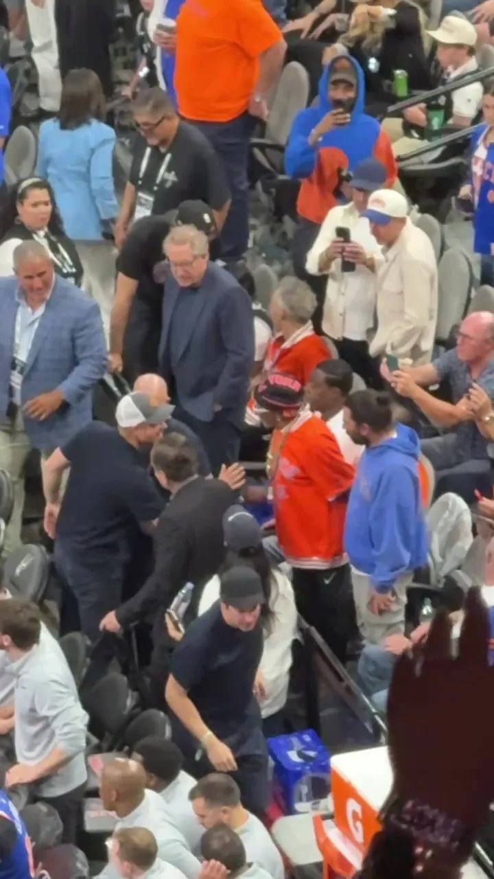 Prince Harry reaching for a handshake with Spike Lee at a Knicks vs. Spurs game.
