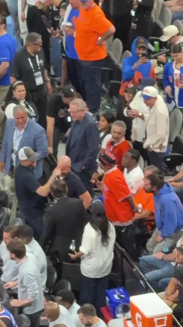A blurry crowd of people at a basketball game.