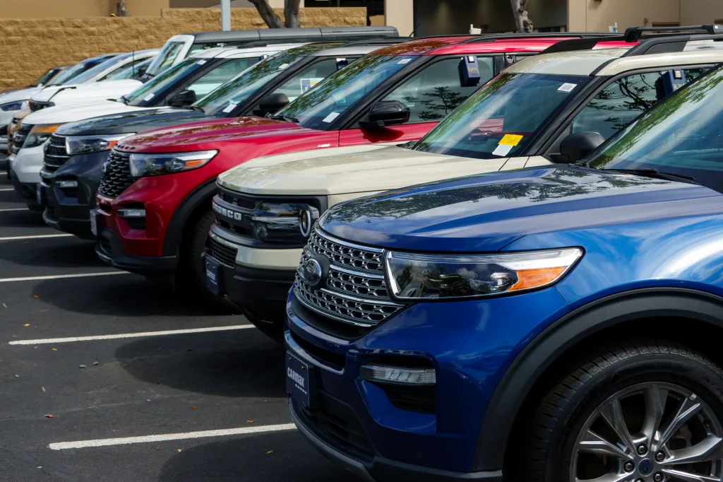 Multiple sport utility vehicles in a CarMax dealership lot.