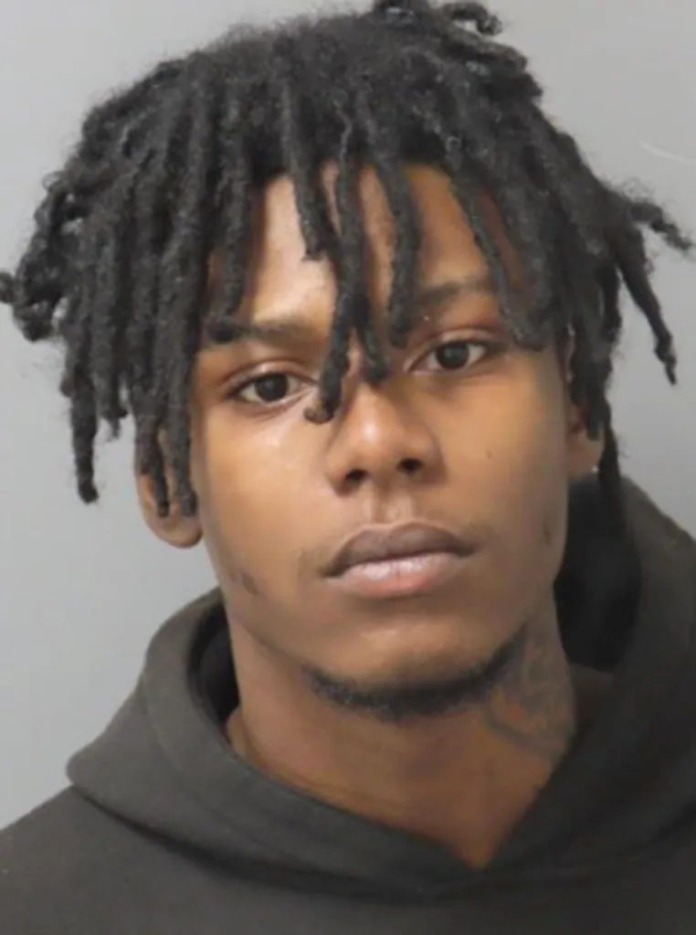 Mugshot of Ca'Marion Pawnell, a young Black man with dreadlocks, wearing a dark hoodie.