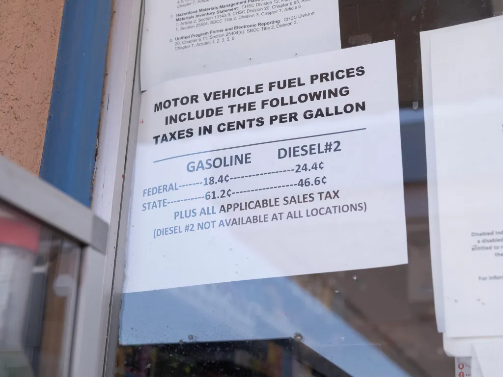 A sign detailing motor vehicle fuel taxes in cents per gallon for gasoline and diesel.