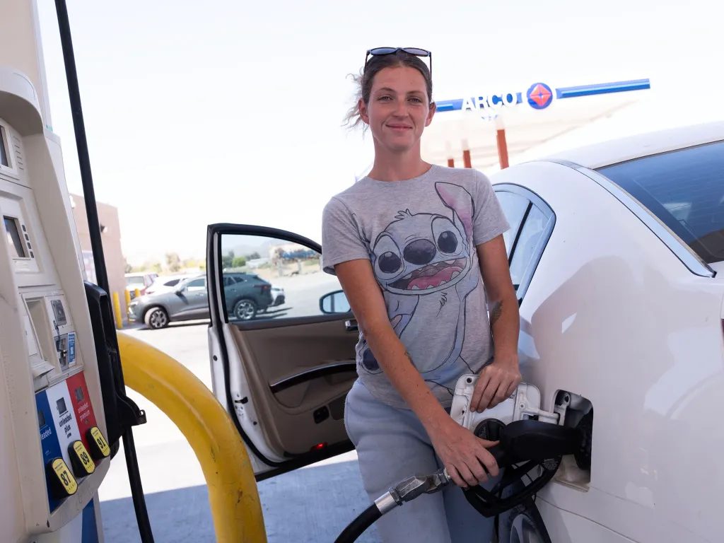 A woman fueling her car at an Arco gas station in Mohave Valley, Arizona.