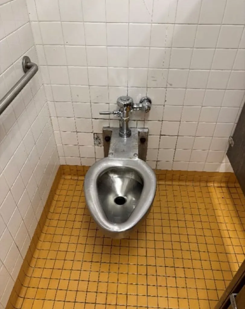 A stainless-steel toilet without a seat in the women's bathroom at 161st Street on the 4 line.