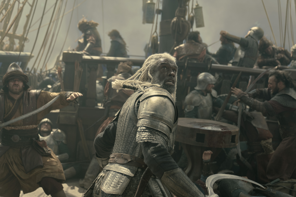 Steve Toussaint as Corlys Velaryon in full armor during a battle at sea.
