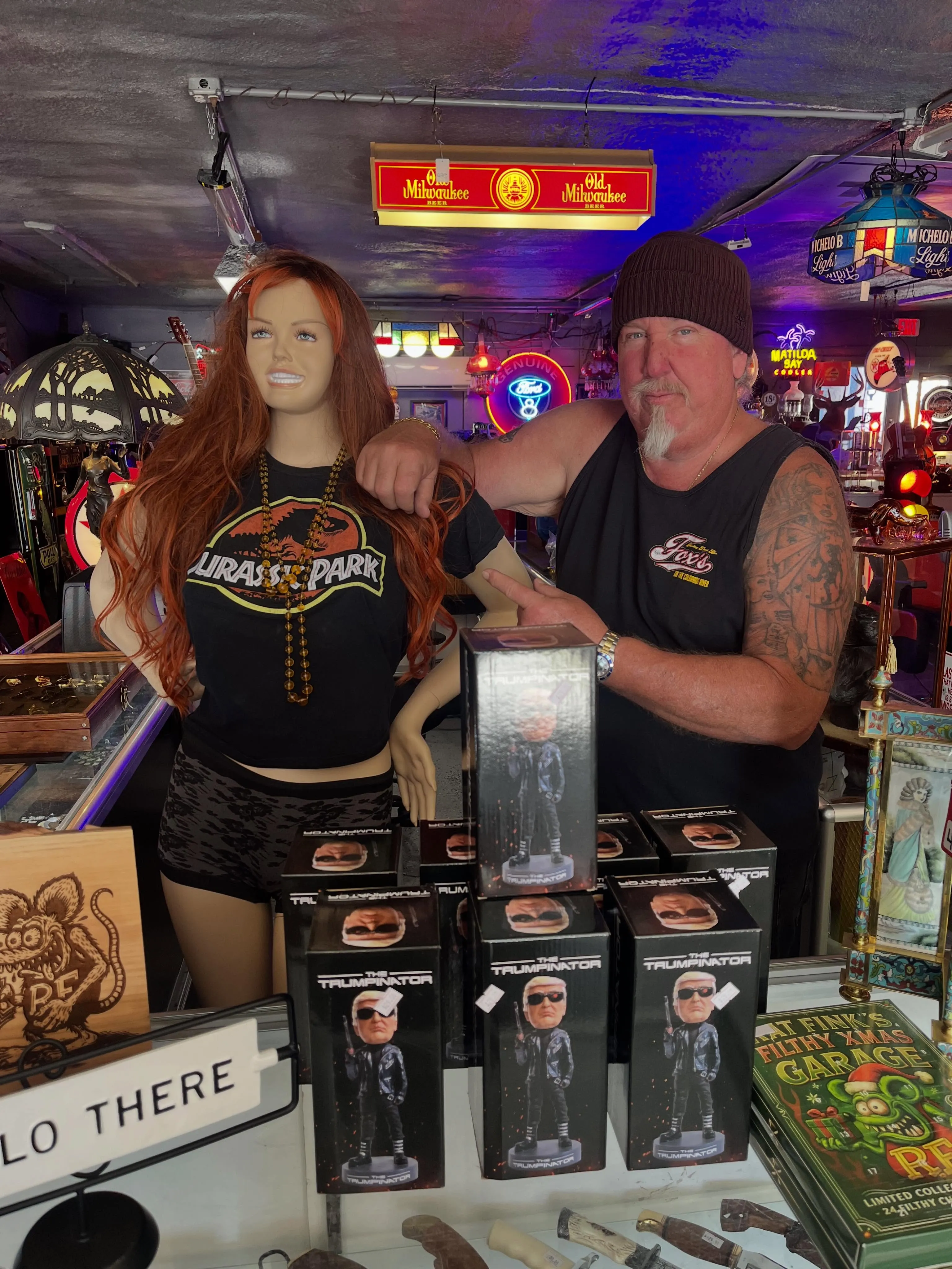 Brandon Sheets standing with a female mannequin and several