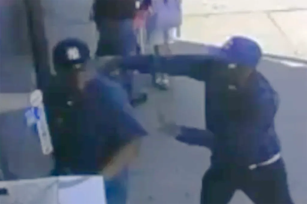 Security footage of an assailant in a blue cap punching a victim.
