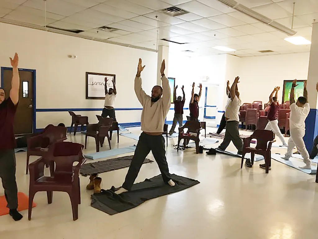 Inmates participating in a yoga class at Delaney Hall.