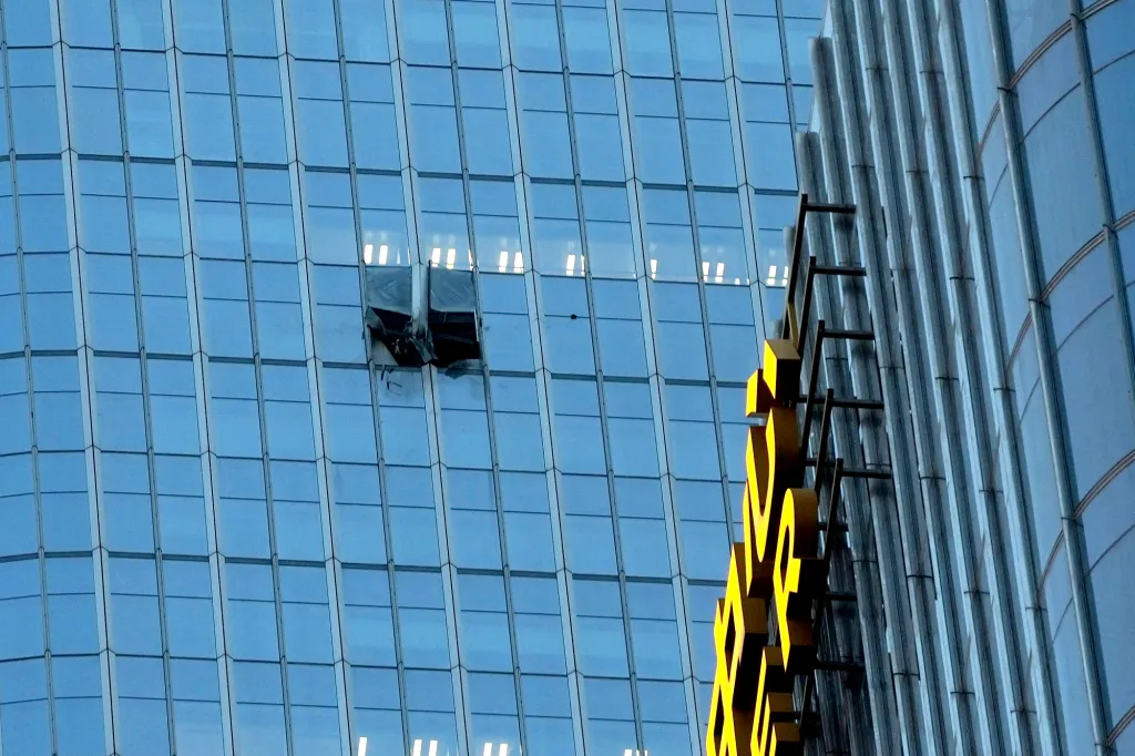 A hole is left in the side of the CITIC Tower after a small plane crashed into it on June 26, 2026.