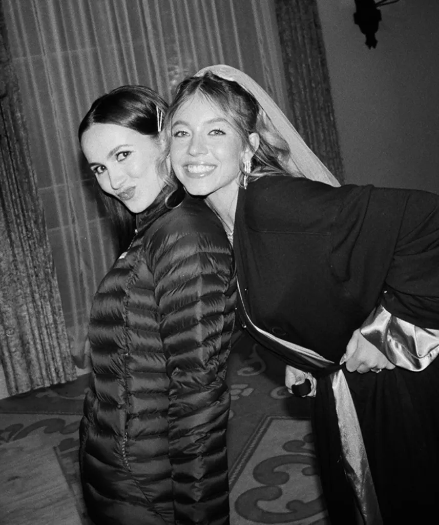Two women posing for a black and white photo.