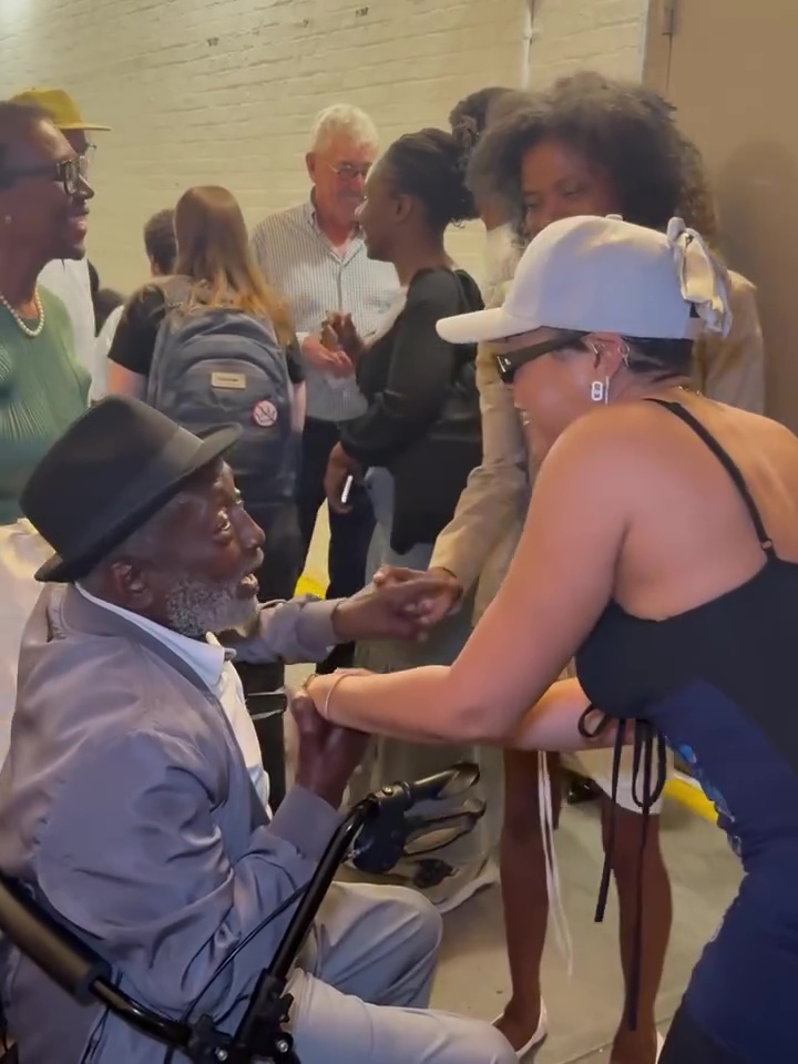 Taraji P. Henson greeting a man in a wheelchair.
