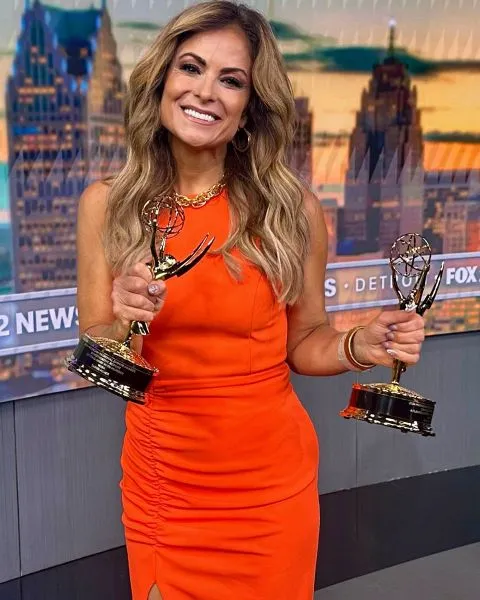 Taryn Asher, a former Detroit TV anchor, holds two Emmy awards.