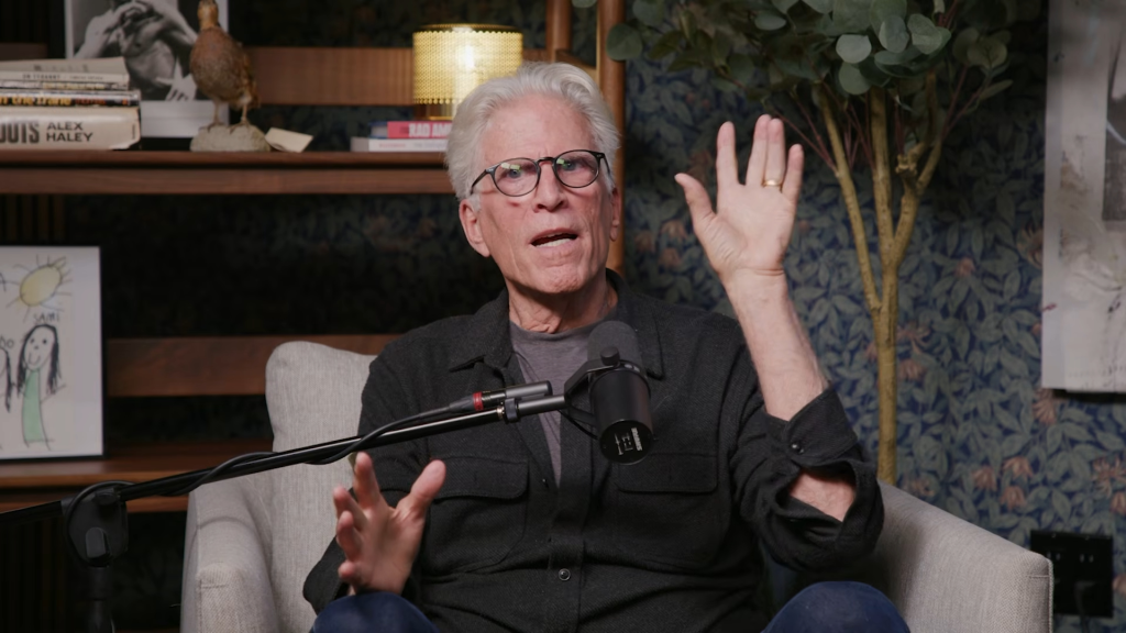 Ted Danson speaking into a microphone.