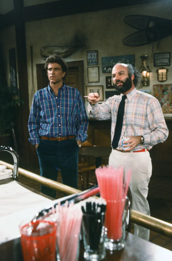 Ted Danson as Sam Malone, and Producer James Burrows at a bar.