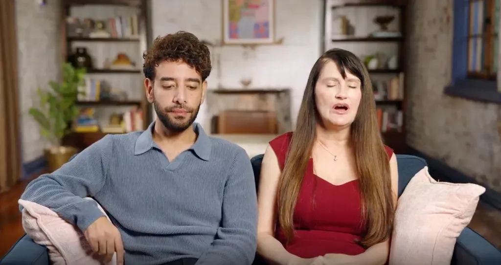 Mido and Debby from 90 Day Fiancé sitting on a couch.