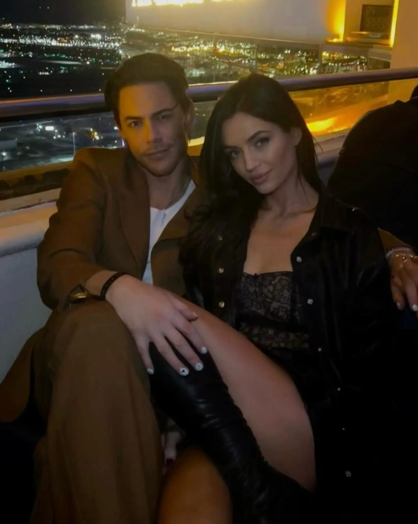 Tom Sandoval and Victoria Robinson posing together at a nighttime event.