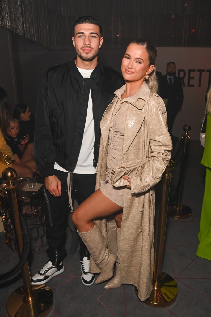 Tommy Fury and Molly-Mae Hague posing together at a PrettyLittleThing event.
