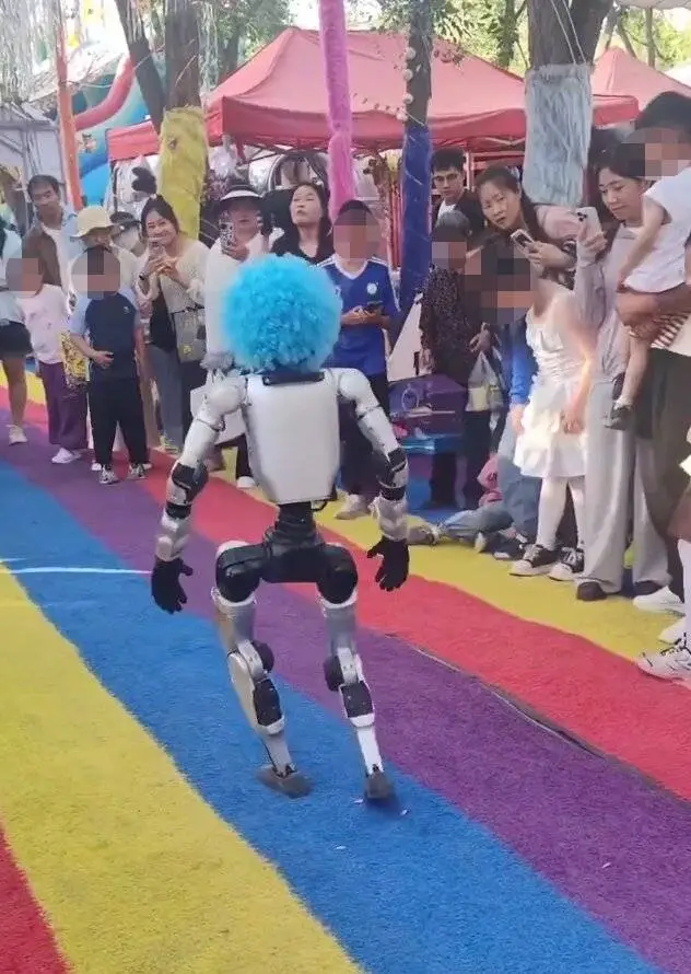 A robot wearing a blue wig as crowd watches