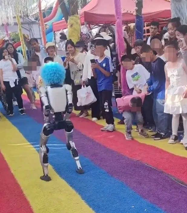 A boy doubled over in pain after a robot kicks him