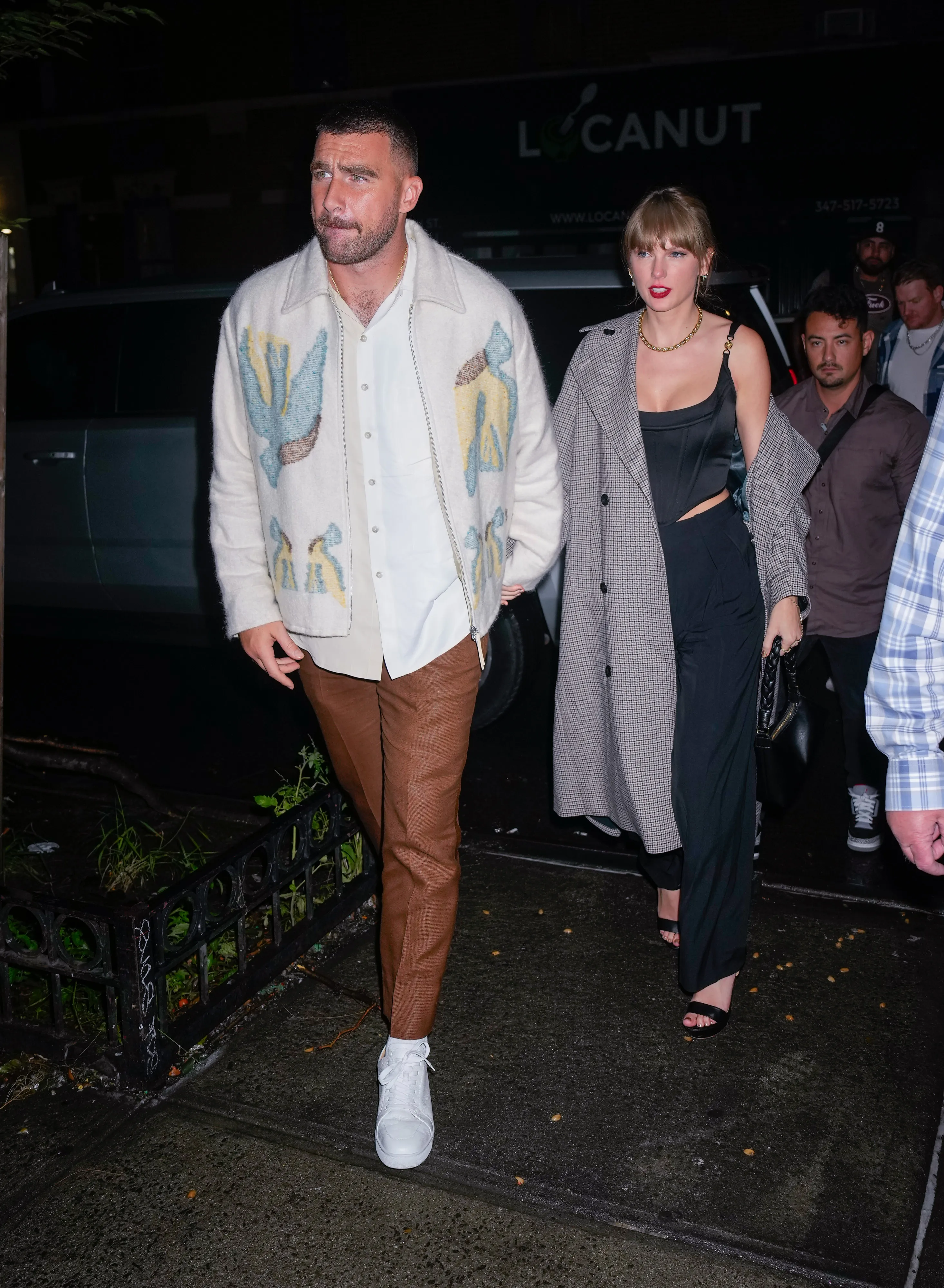Travis Kelce and Taylor Swift arriving at an SNL afterparty in New York City.