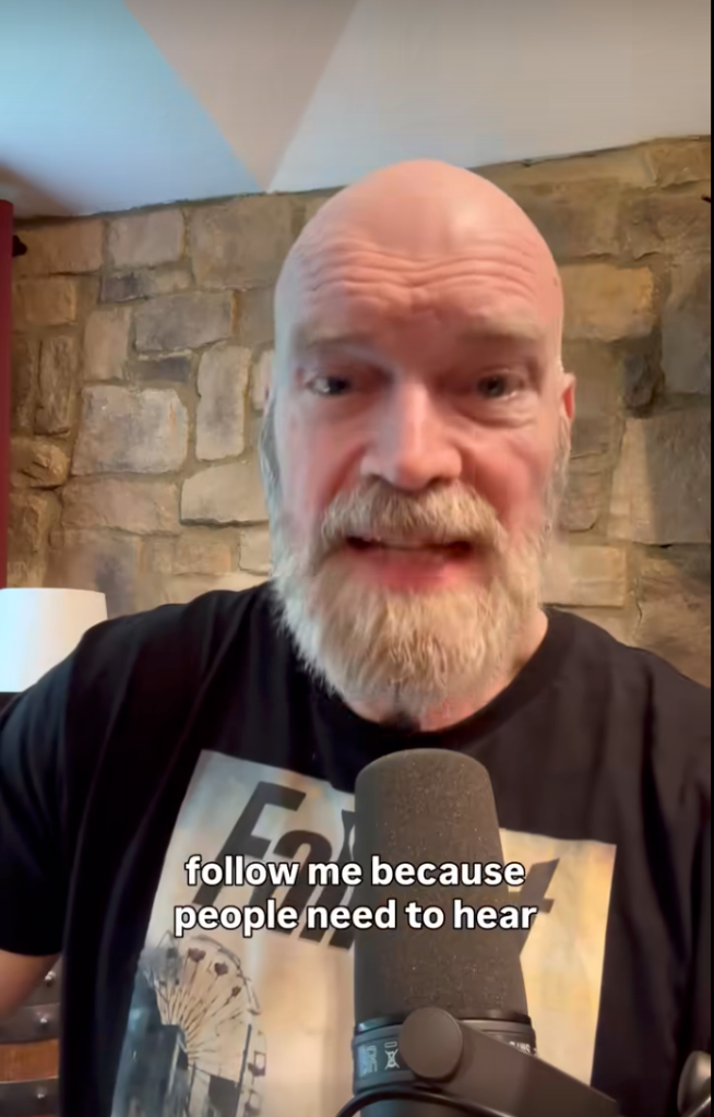 Tyler Mane speaking into a microphone.
