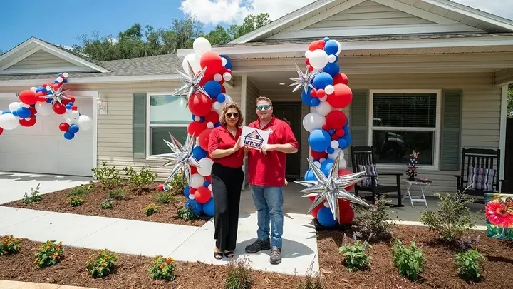 U.S. Army Sergeant James Tabares and his wife pose in front of their new home built by The Villages Charter School Construction Management Academy students and Building Homes for Heroes.