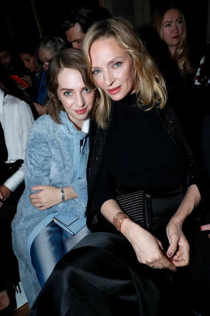 Uma Thurman and her daughter Maya Hawke sitting together at a fashion show.