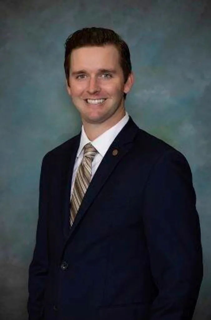 Lee Vogler, Danville City councilmember, smiles in a headshot against a blue-green backdrop.