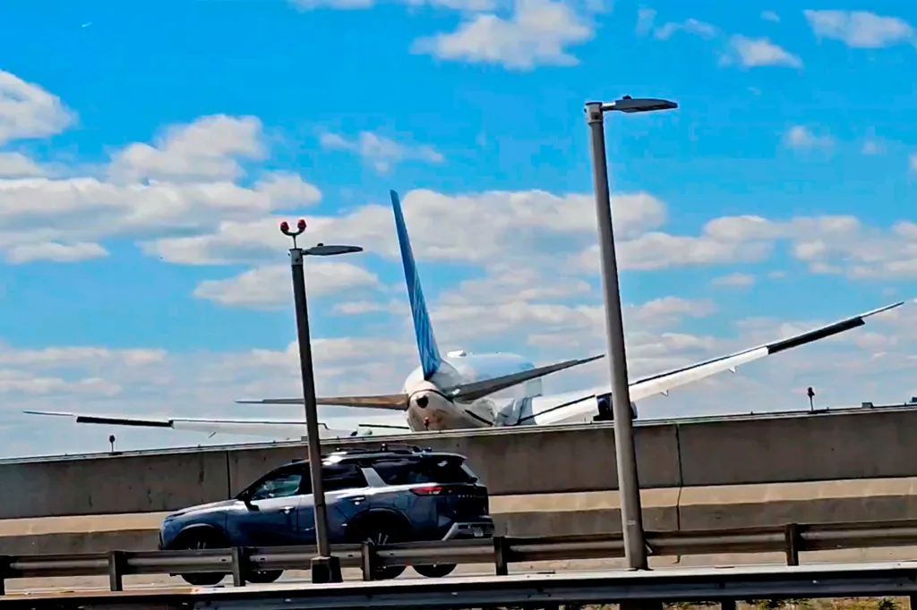 A United Airlines plane on the ground with its wing visibly damaged after hitting a light pole.