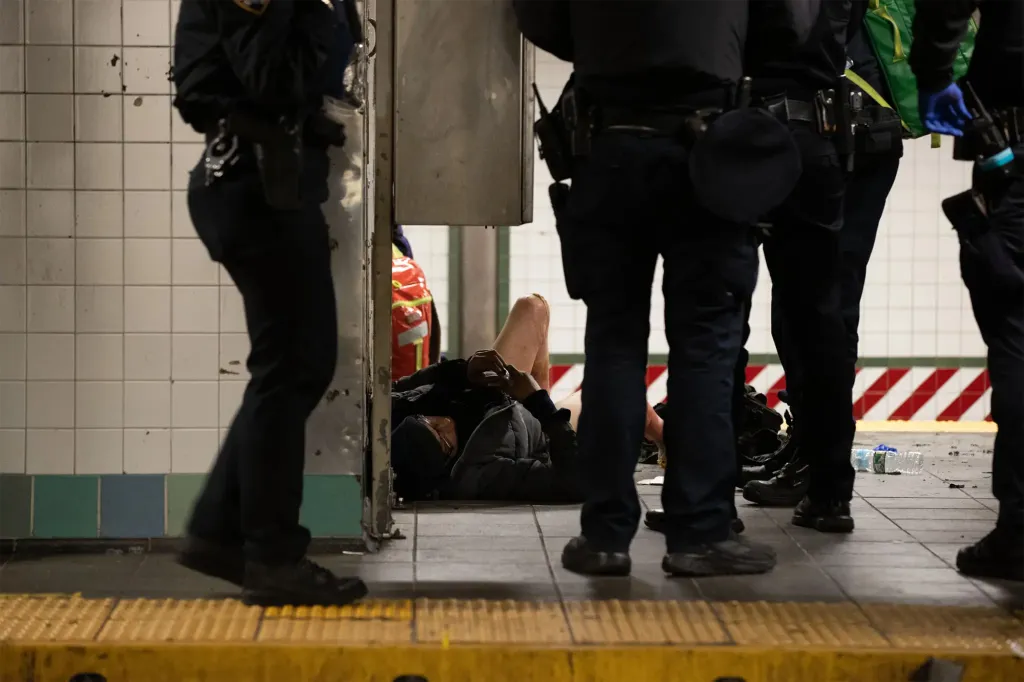 First responders work on the arson victim at the 42nd Street and Times Square subway station on Dec. 1, 2025.