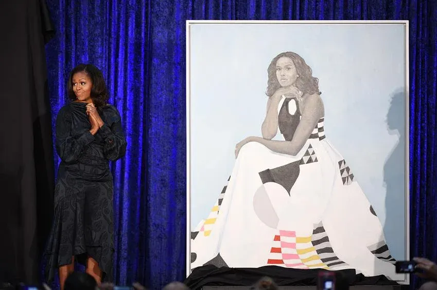 Michelle Obama stands next to her portrait at the Smithsonian National Portrait Gallery on Monday Feb. 12, 2018 in Washington, D.C. Source: Getty