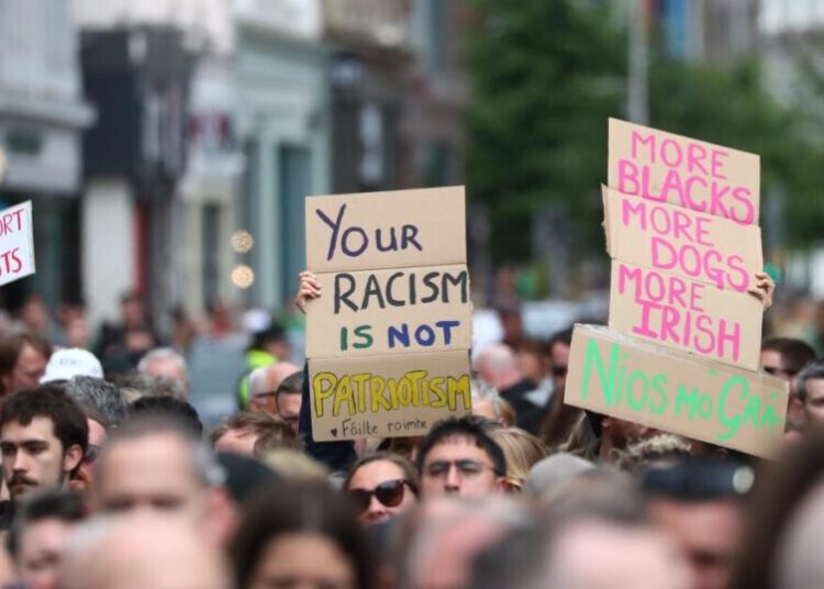 Thousands rally in Belfast to condemn racism and anti-immigrant rioting that followed stabbing