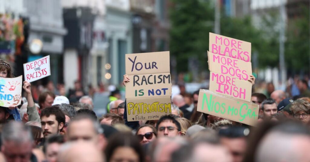 Thousands rally in Belfast to condemn racism and anti-immigrant rioting that followed stabbing