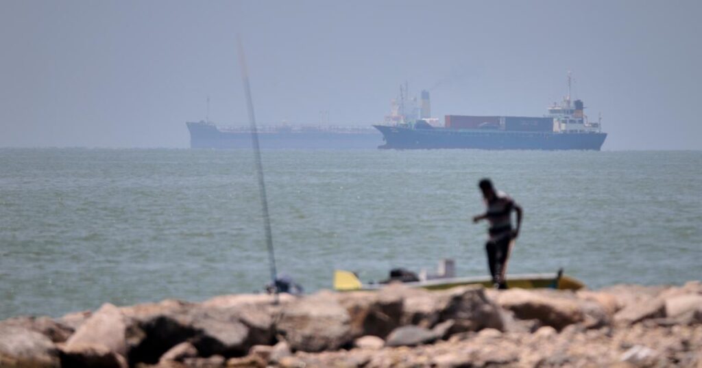 Iranian drones attack Bahrain and a ship is struck in the strait after U.S. airstrikes