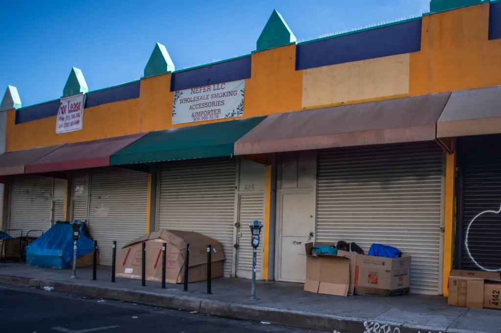 A homeless person sits inside a makeshift cardboard shelter in the Skid Row area of downtown Los Angeles.