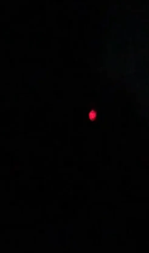 A red glowing orb against a black background.