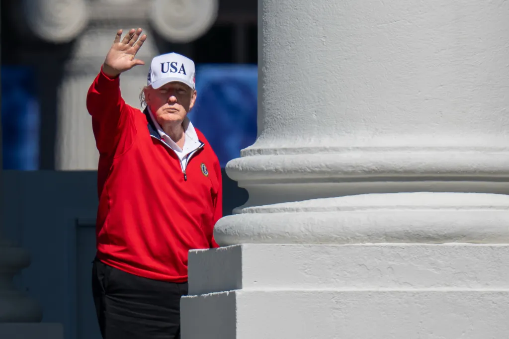 Donald Trump in a red shirt and a white 