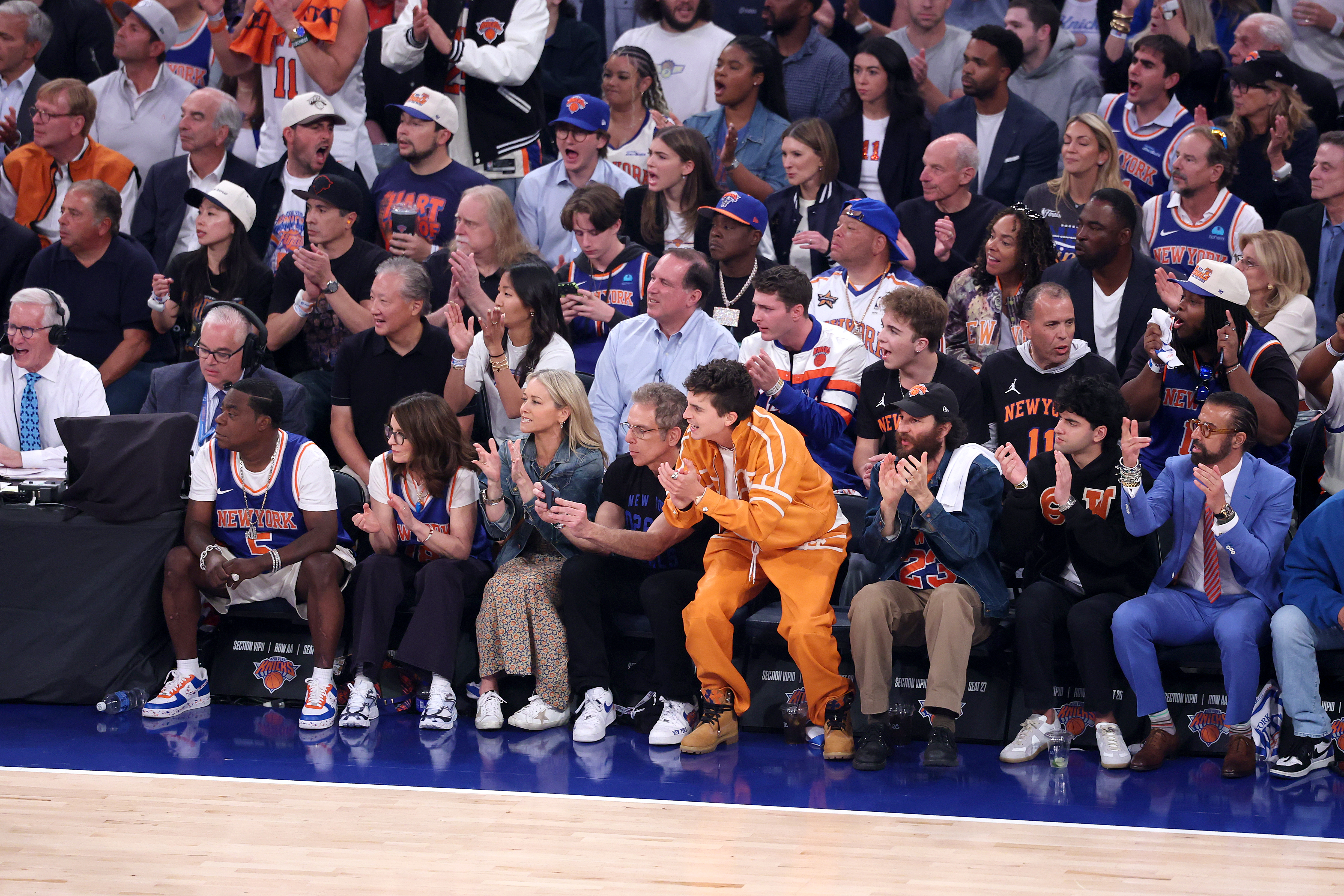 Celebrities Tracy Morgan, Tina Fey, Christine Taylor, Ben Stiller, and Timothée Chalamet watching the NBA Finals.
