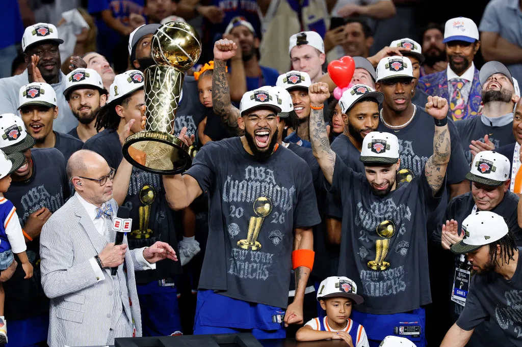 Karl-Anthony Towns and the New York Knicks celebrate winning the 2026 NBA Finals with the Larry O'Brien Championship Trophy.