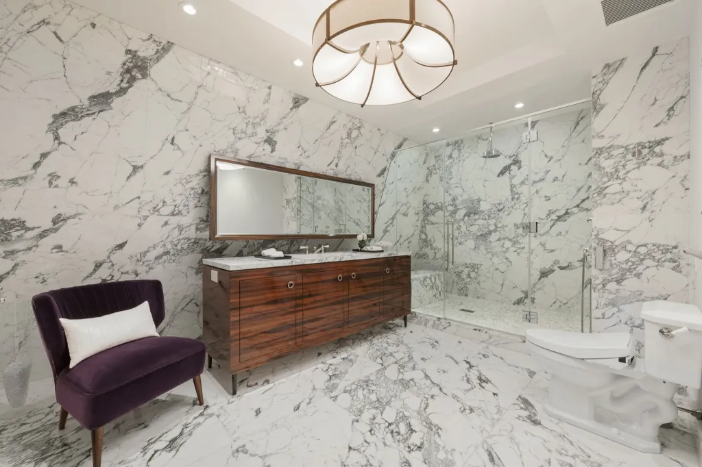 A handsome stone-clad bathroom.
