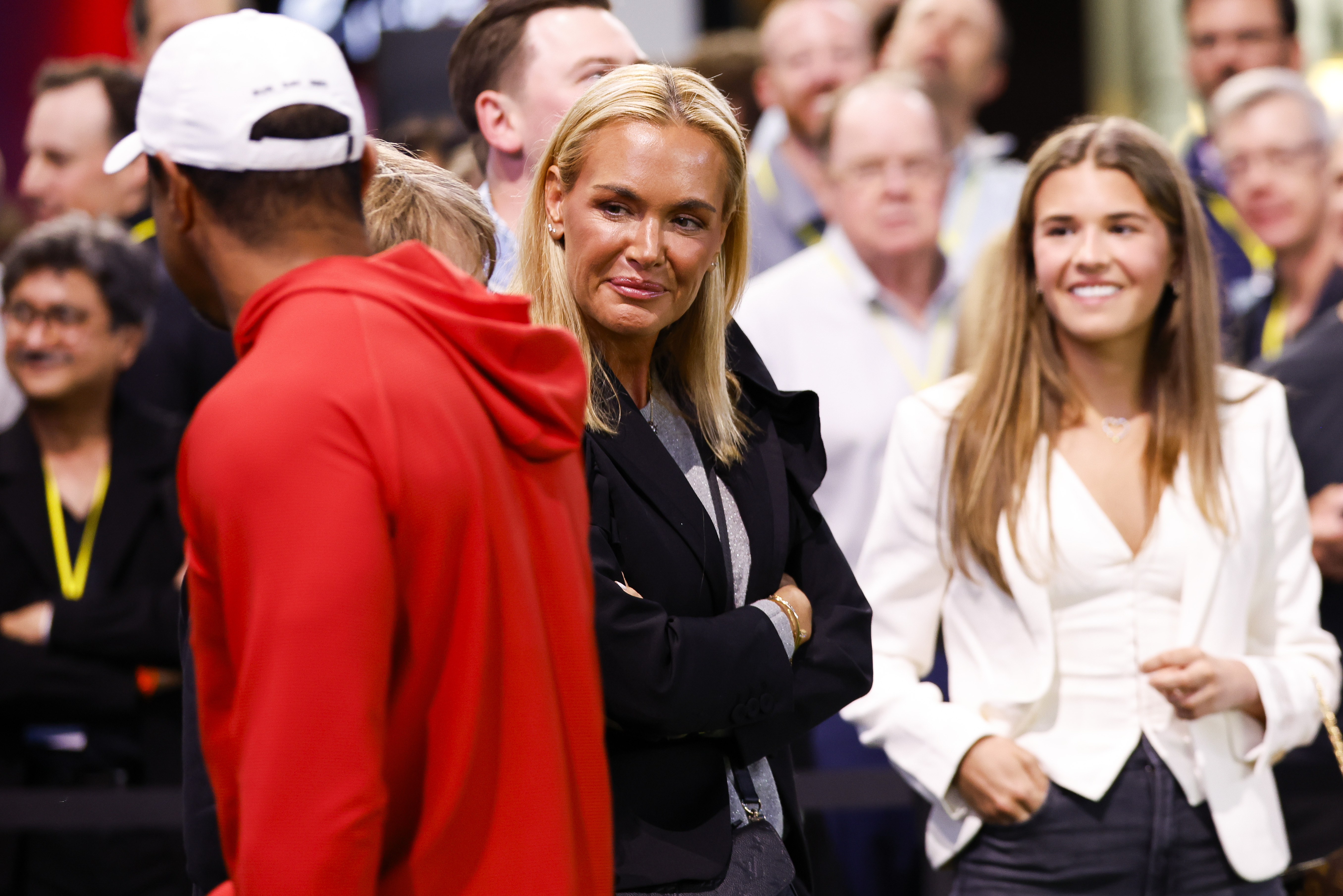Vanessa Trump, girlfriend of Tiger Woods, and her daughter Kai Trump talk with Woods.