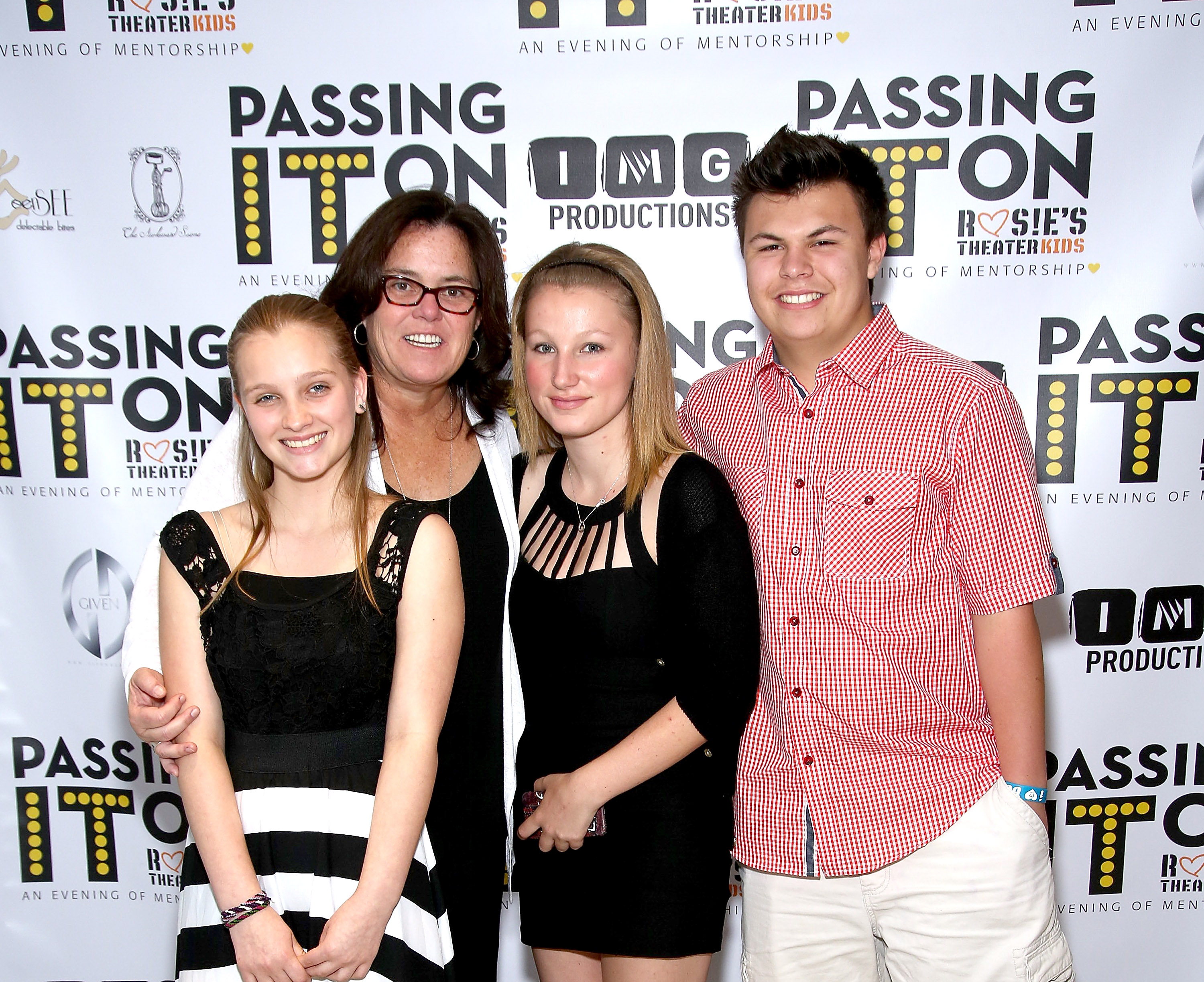 Rosie O'Donnell and three of her children, Vivienne, Chelsea, and Blake, standing on a red carpet.