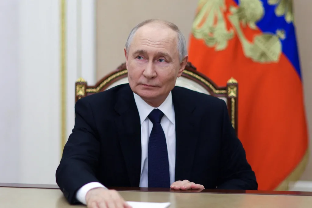 Vladimir Putin seated at a desk, delivering a video address.