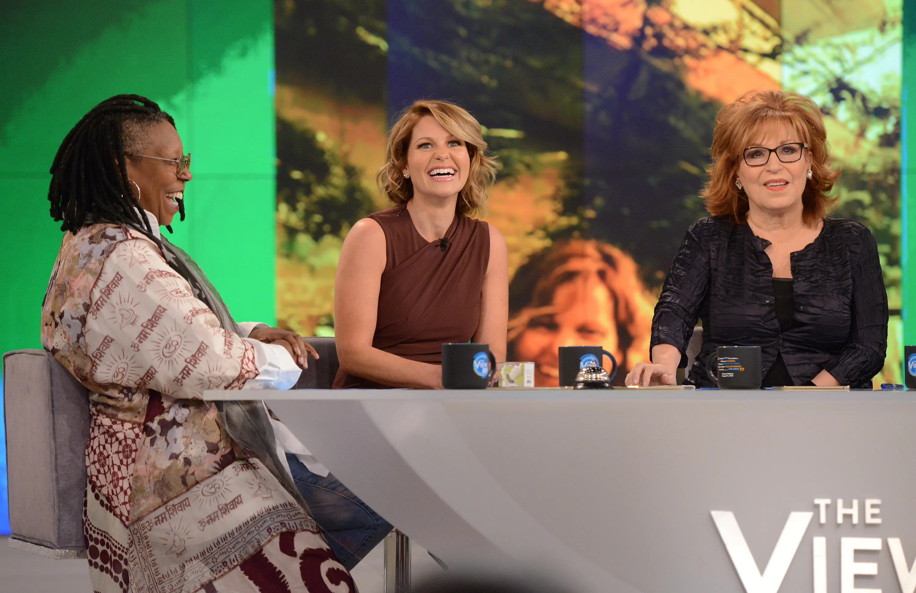 Candace Cameron Bure, Whoopi Goldberg, and Joy Behar at the host's table of 