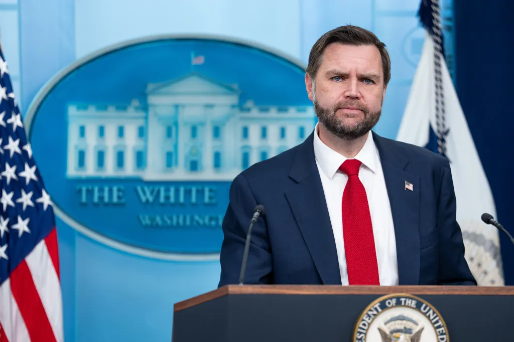 JD Vance speaking at a press briefing in the White House.