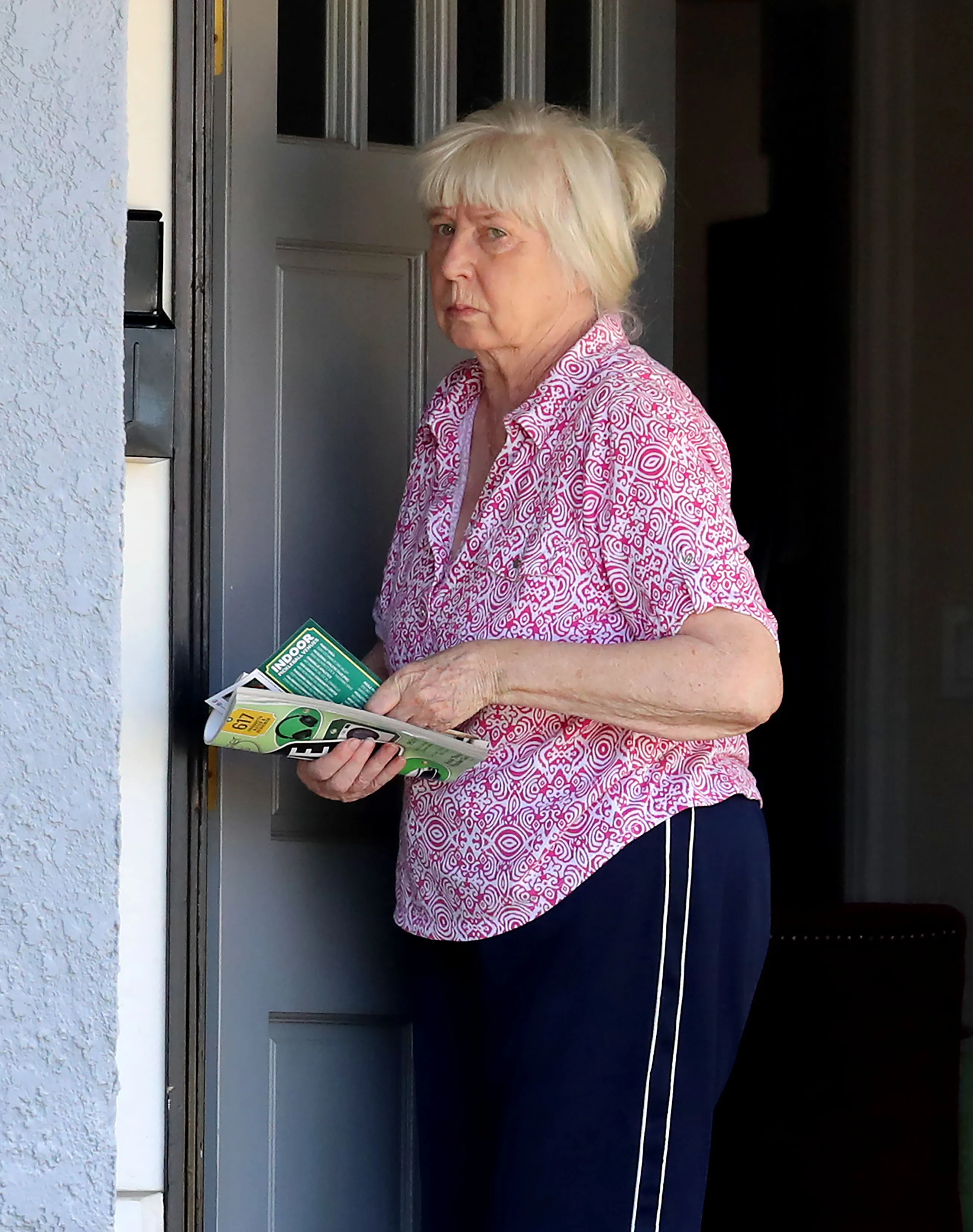 Wendy Gledhill collecting mail outside the home where actor James Handy was murdered.