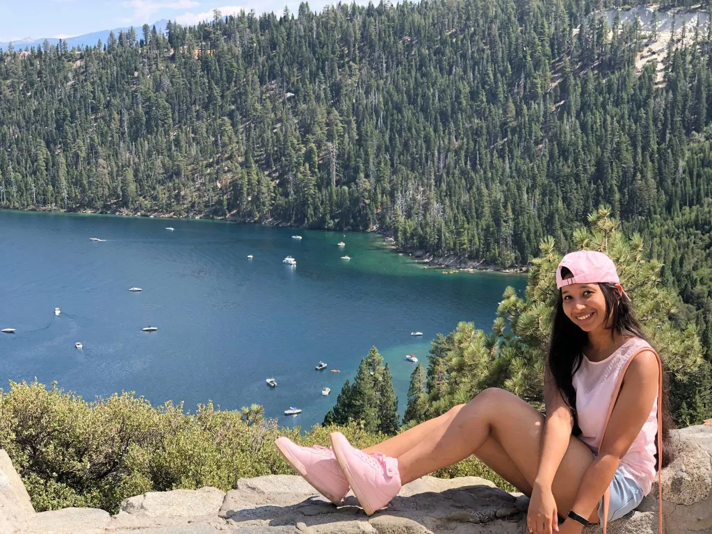 A photo of the victim sitting outside in front of a lake. 