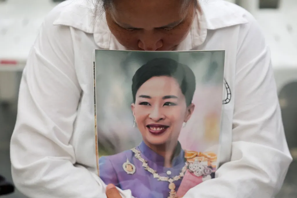 A woman reacts as she holds a picture of Thailand's Princess Bajrakitiyabha, following the announcment of her death.